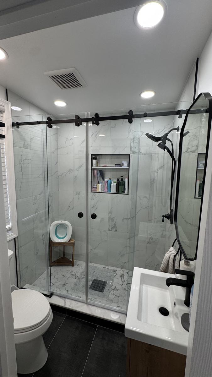 Frameless single sliding shower door with matte black hardware